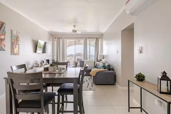 Luxury bedroom with crisp white linens and soft natural light from the balcony